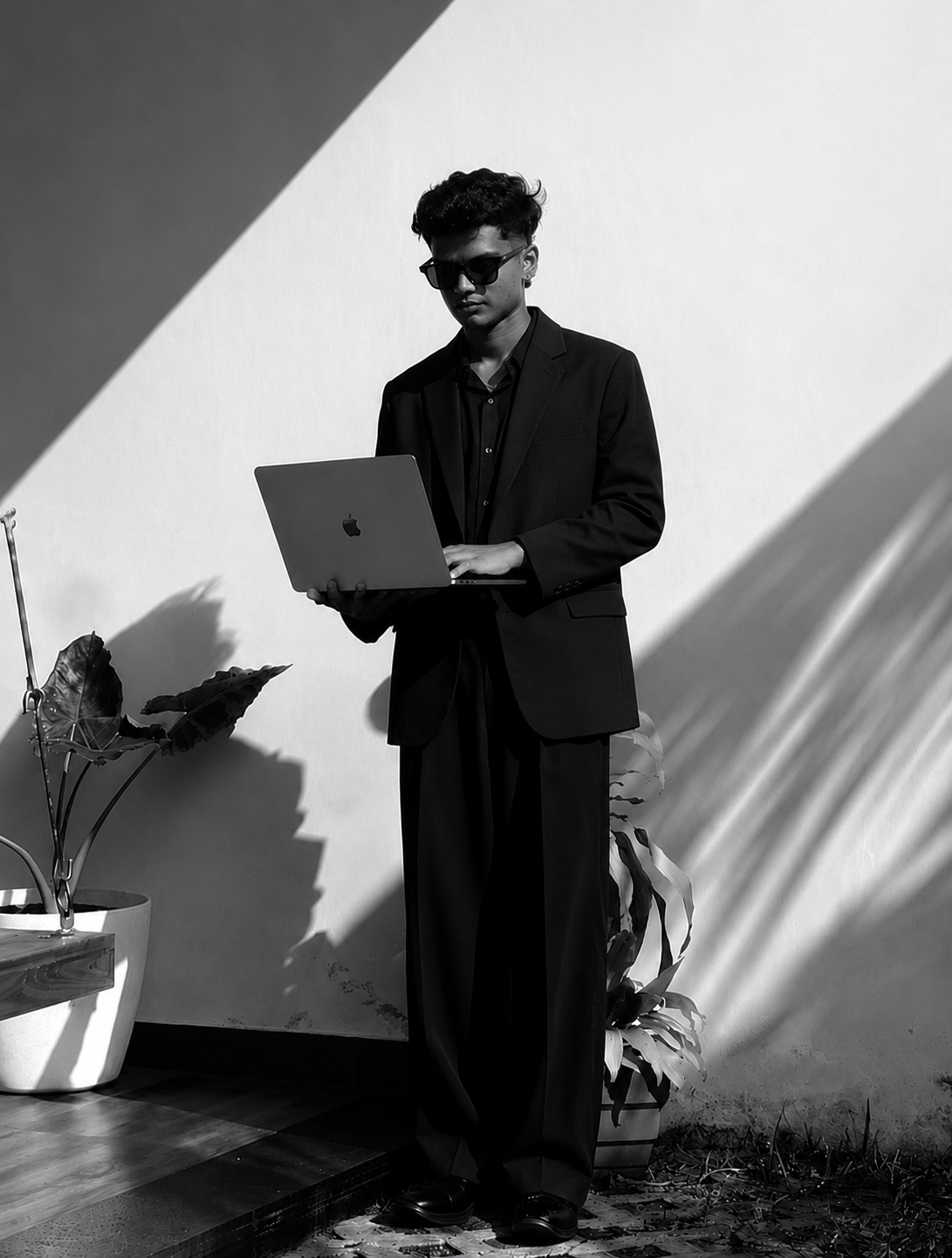 Muhammed Sidhan M, Digital Marketing Strategist in Malappuram, Kerala, working on a laptop in a professional business portrait.